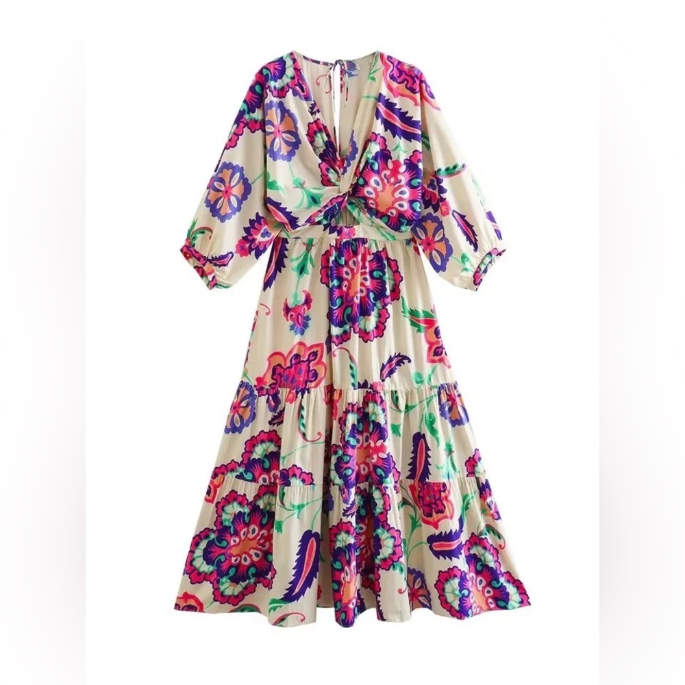 Beautiful floral cutout dress ruffles at bottom with puffy sleeves.